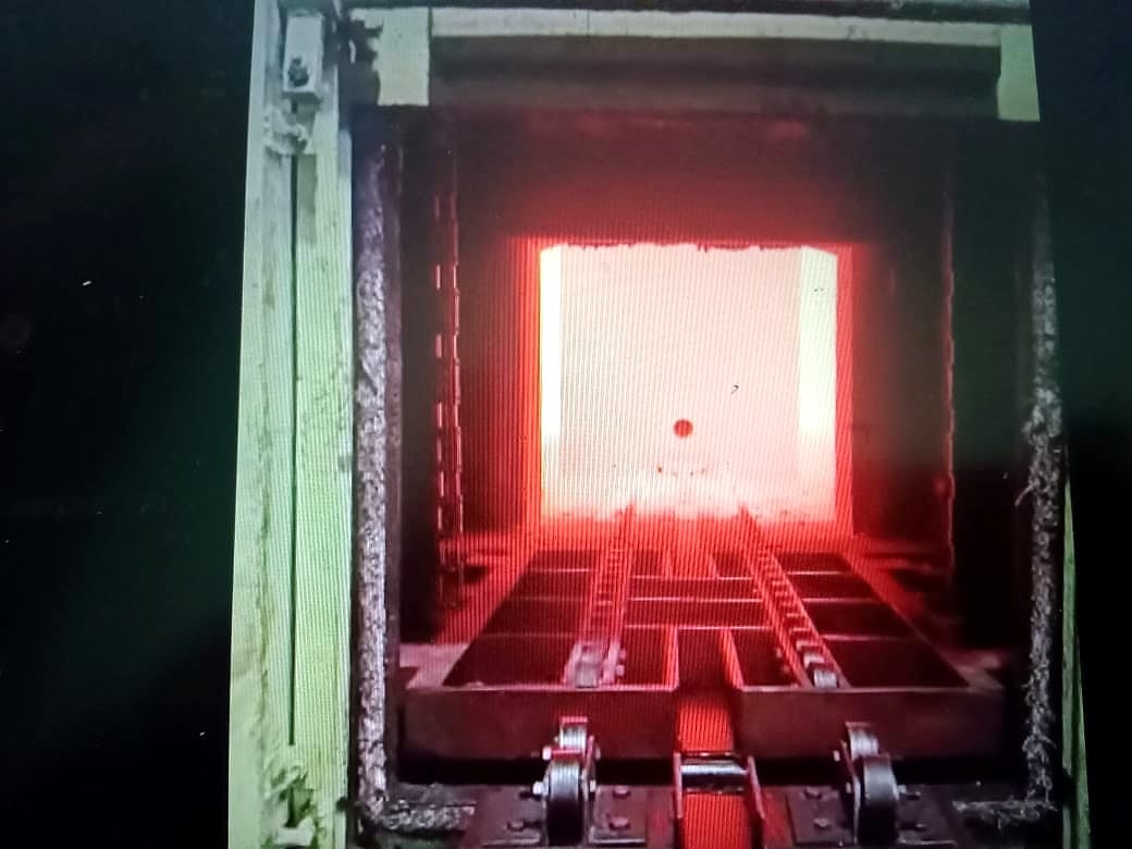 Converted sealed quench furnace chamber glowing at operating temperature, door open