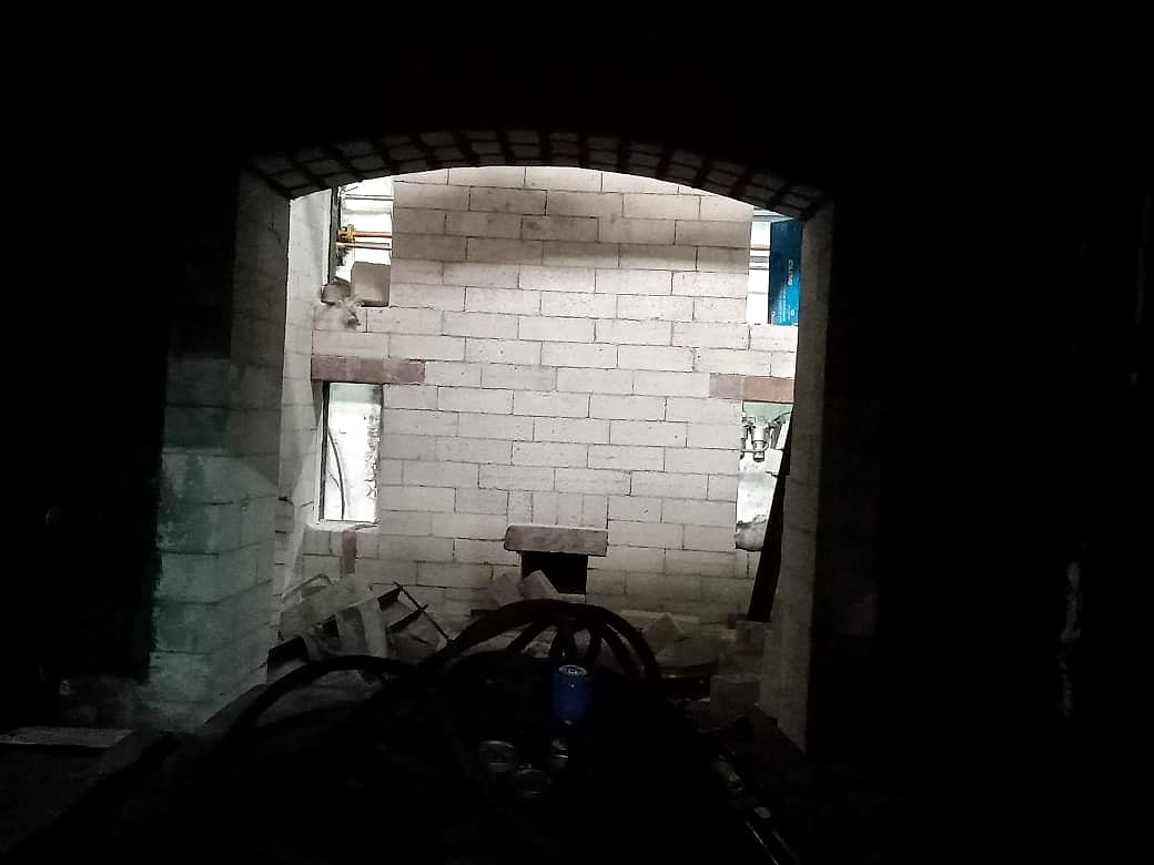New refractory brick lining inside the chamber, seen through the door