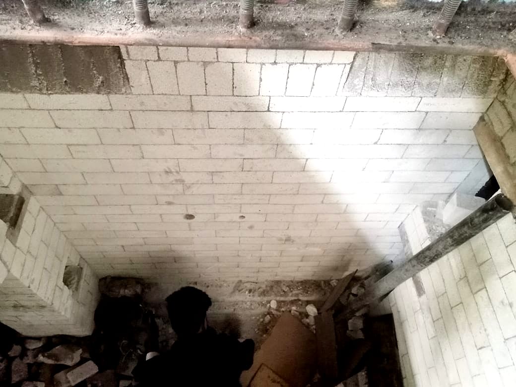Brick-lined chamber with lining work in progress