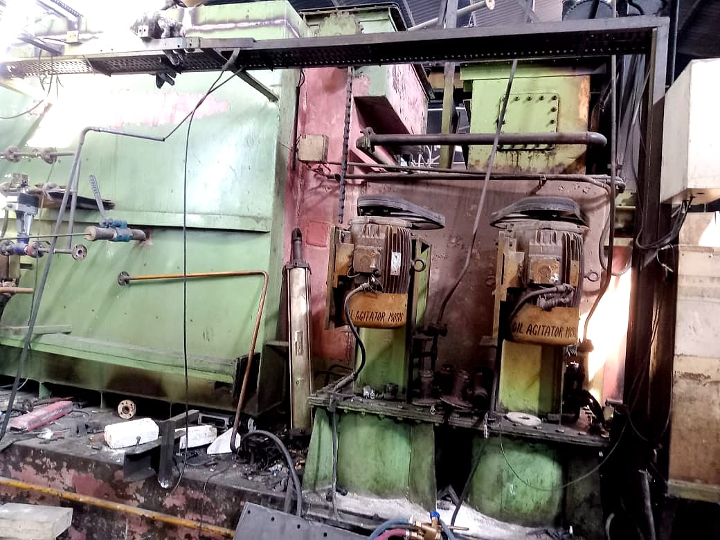 Side of the gas-fired furnace with the quench-oil agitator motors and pipework