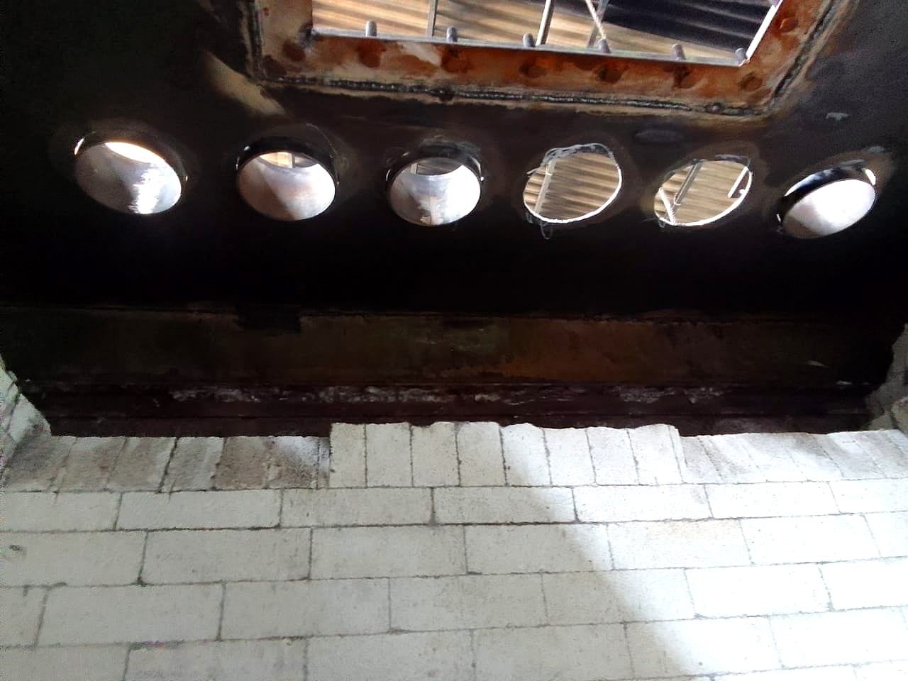 Row of radiant tube openings above the new brick lining