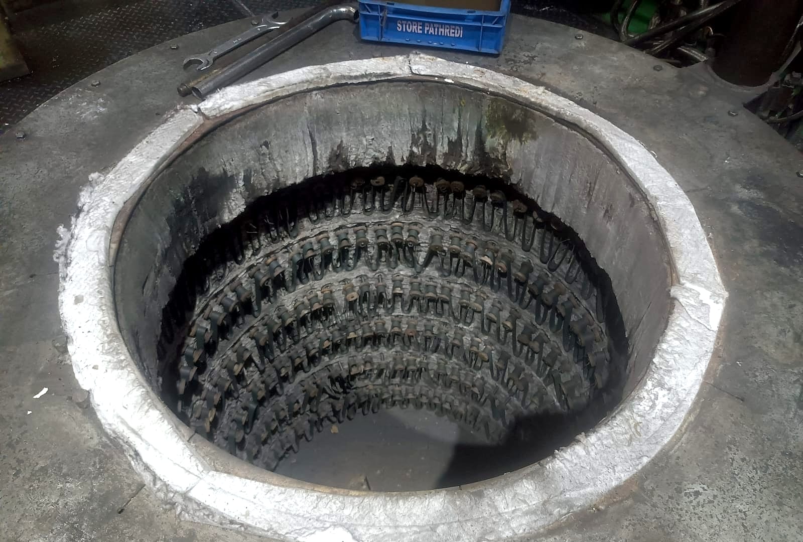 The furnace pit before the retrofit, lined with old strip-type heating elements