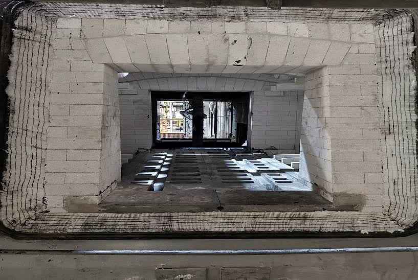 Furnace chamber after the retrofit: new light-coloured brick lining and rebuilt hearth