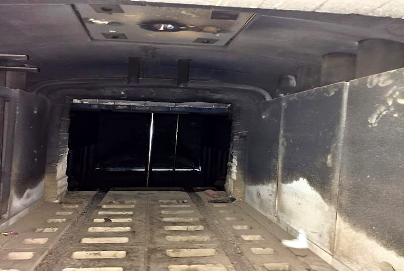 Furnace chamber before the retrofit: soot-blackened lining and worn hearth
