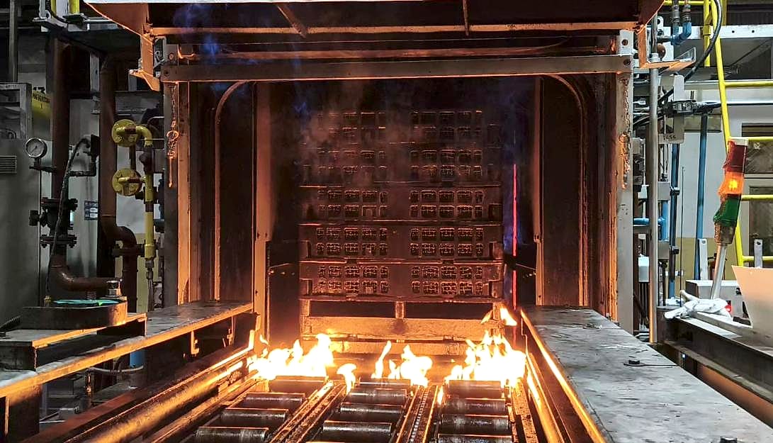 Furnace door open during the trials, flame curtain burning at the entry