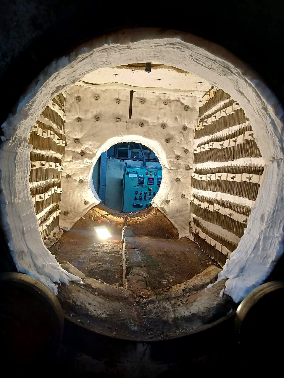 Furnace chamber seen through its door: ceramic fibre lining with rows of heating elements on ceramic supports along both walls
