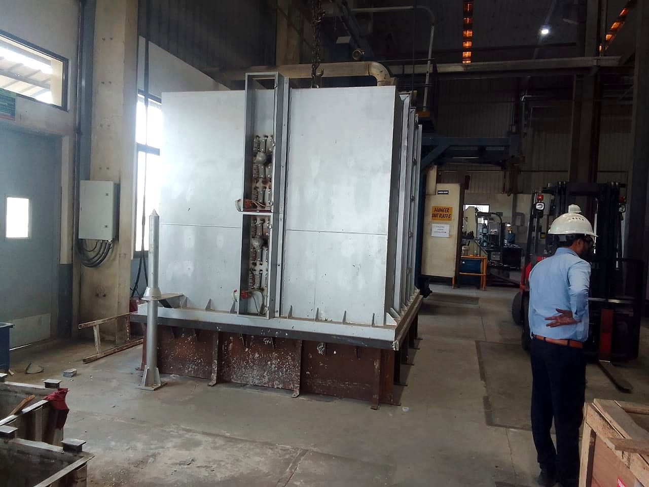 The bell furnace installed at the customer's plant, with heating element terminal boxes along its side